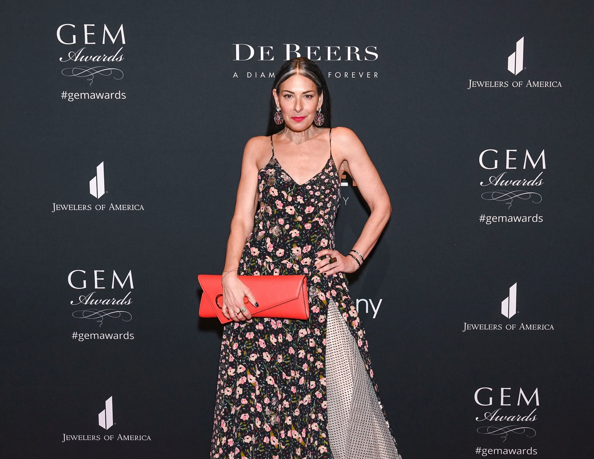 Stacy London posing and wearing a floral dress at the 20th annual GEM Awards