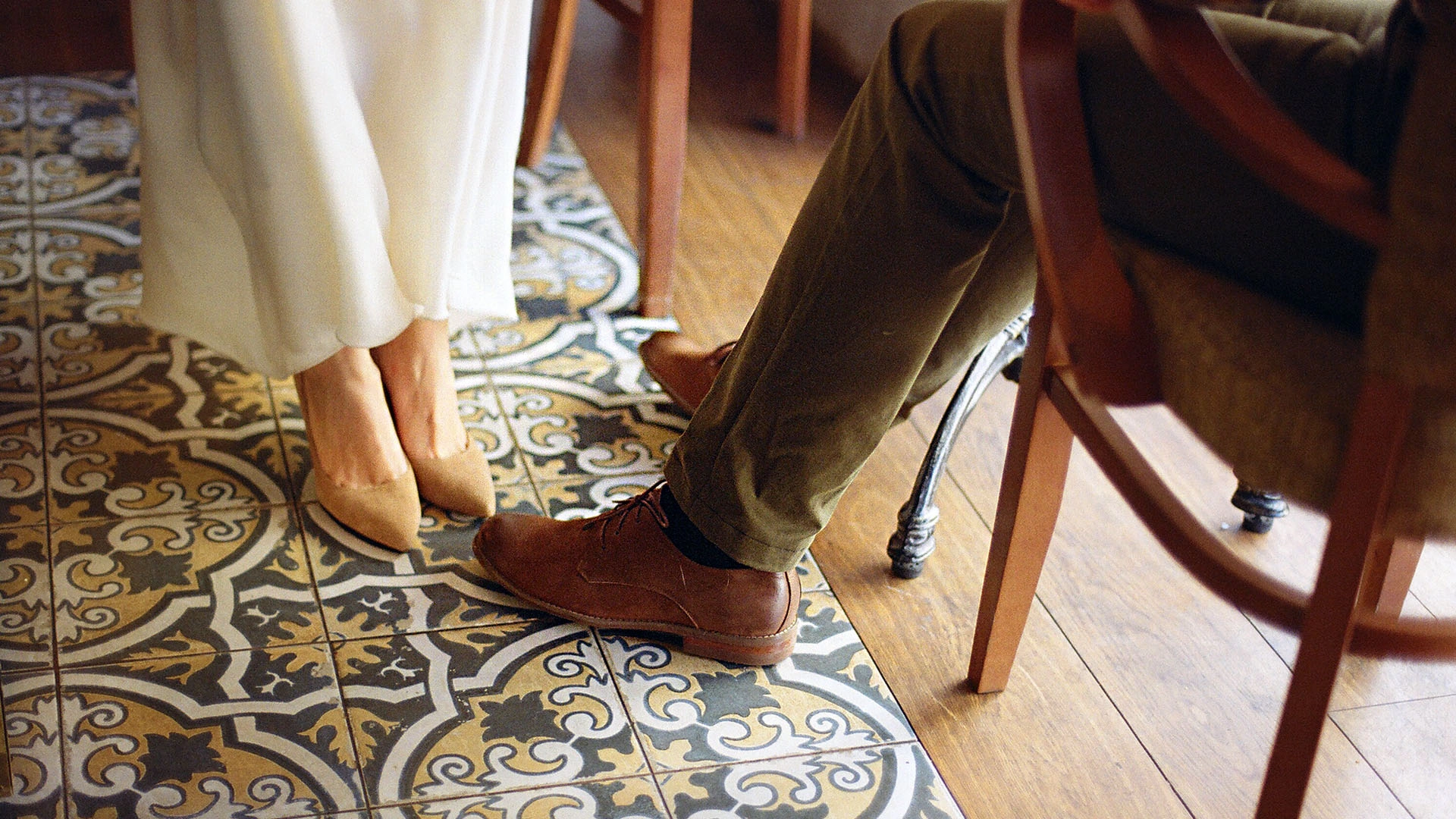 Couple sitting in a cafe with a close up of their legs