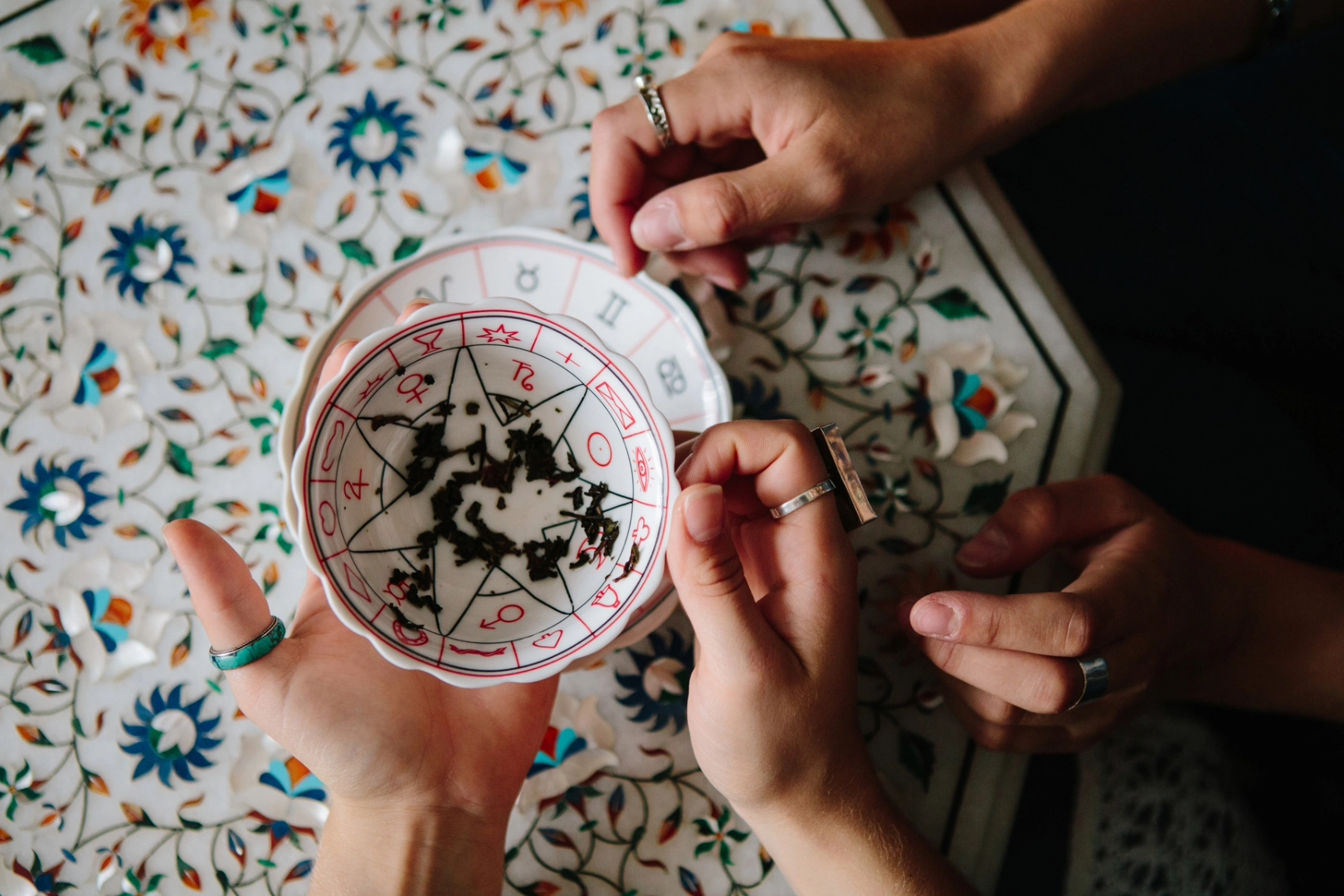 A fortune teller reads the tea leaves in a fortune cup to see what is ahead for 2024.