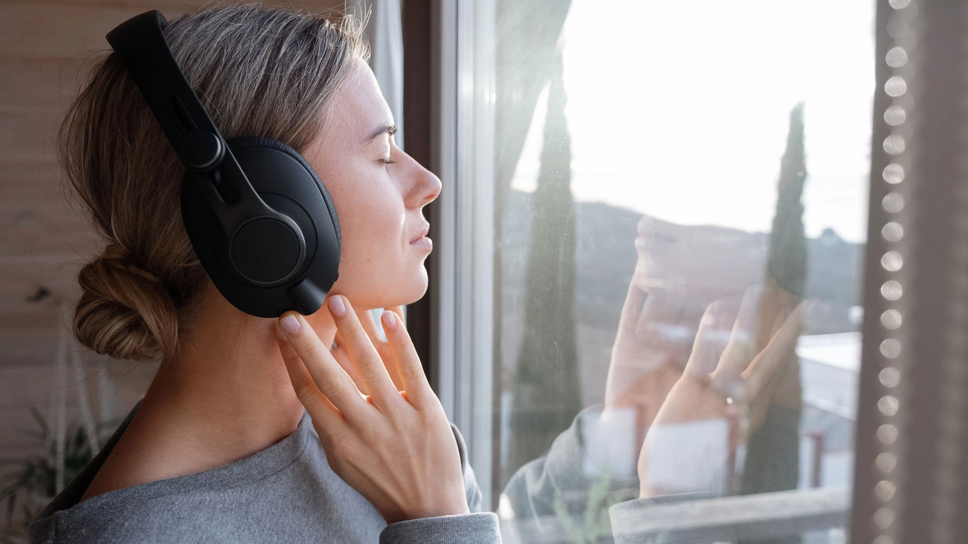 Woman uses her headphones to explore sensory wellness technology.