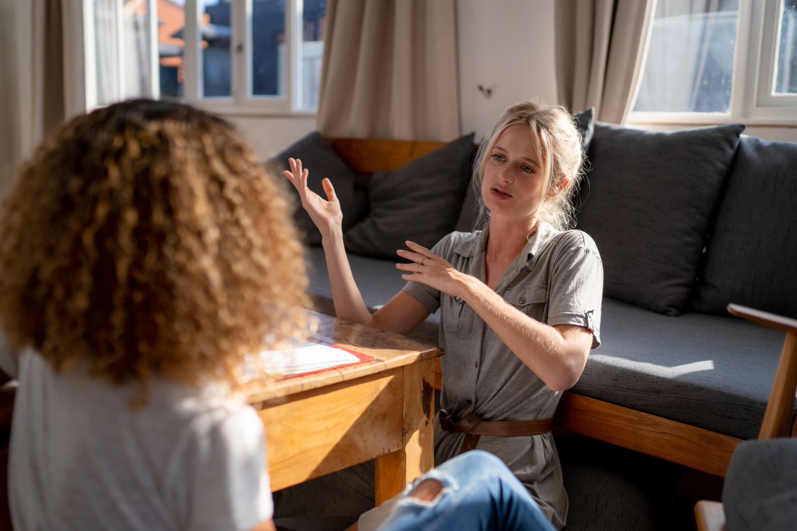 Two women sitting in a sunny living room meet to do an Akashic Record reading.