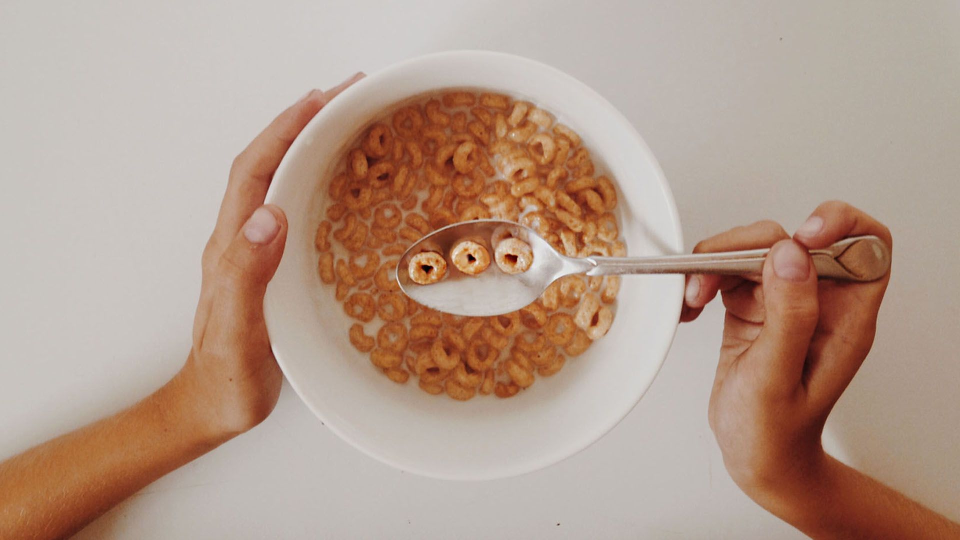 Bowl of circular-shaped cereal with the angel number 000 on the spoon