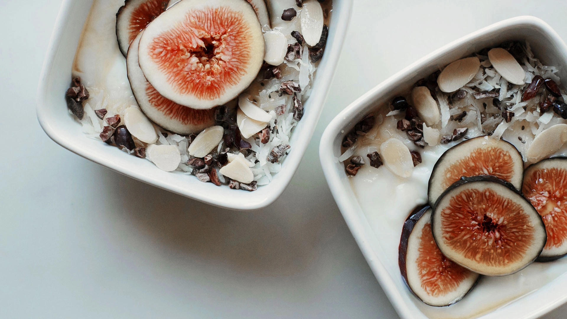 Breakfast bowl of yogurt with figs and sliced almonds for building muscle