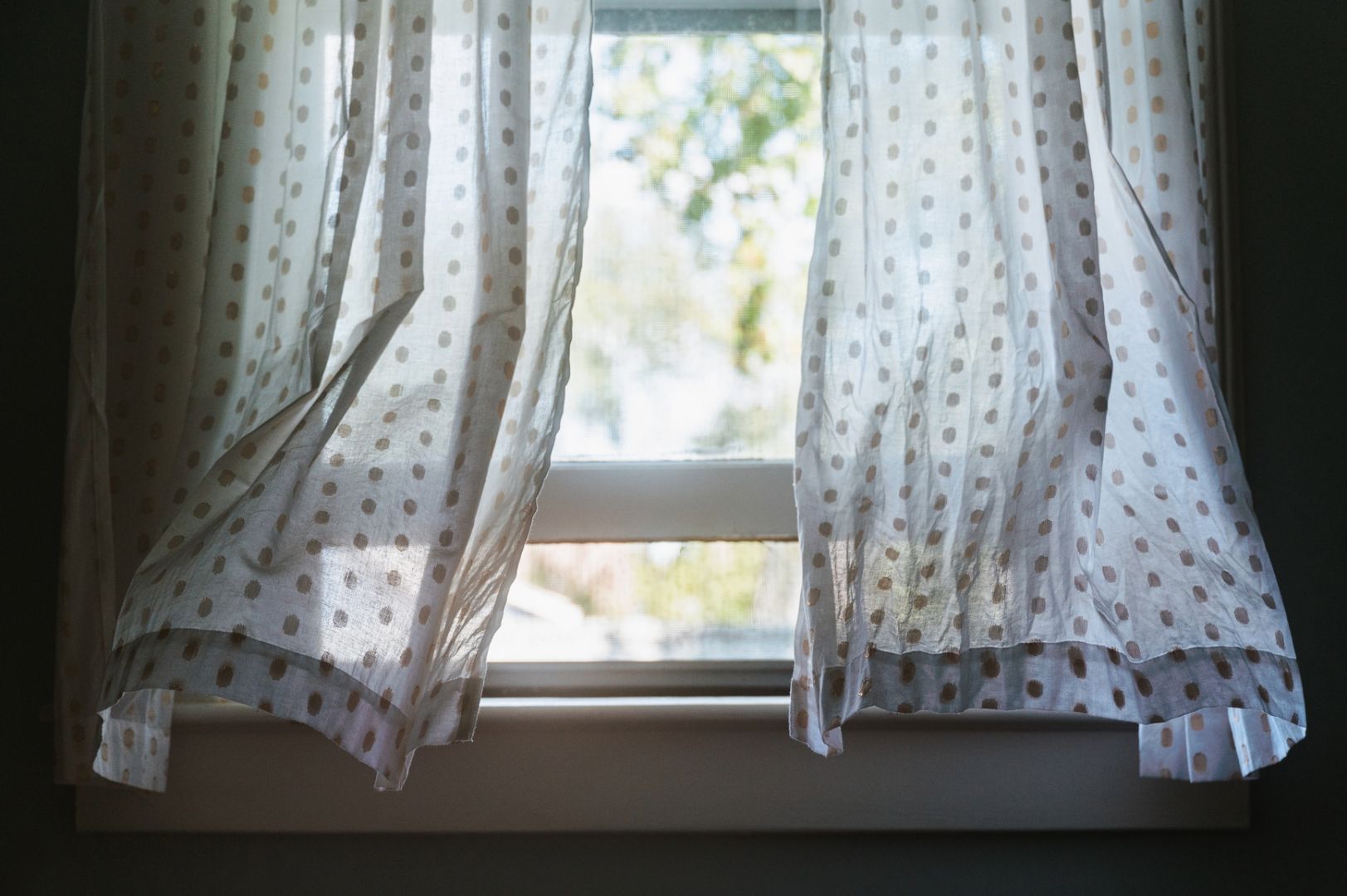 Wind blowing forcefully through opened windows in a haunted house