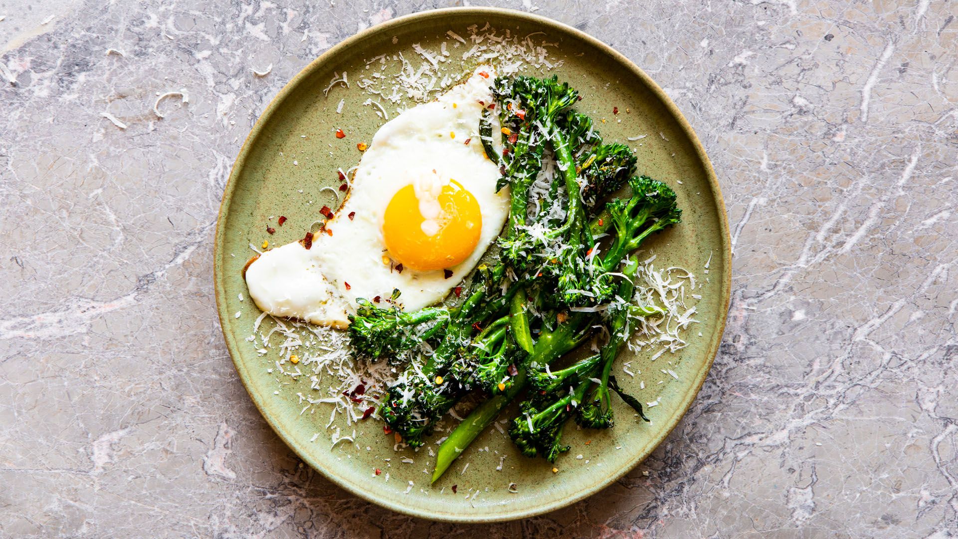 A nutritious and delicious protein-packed meal of broccoli and egg with parmesan cheese sprinkled on top.