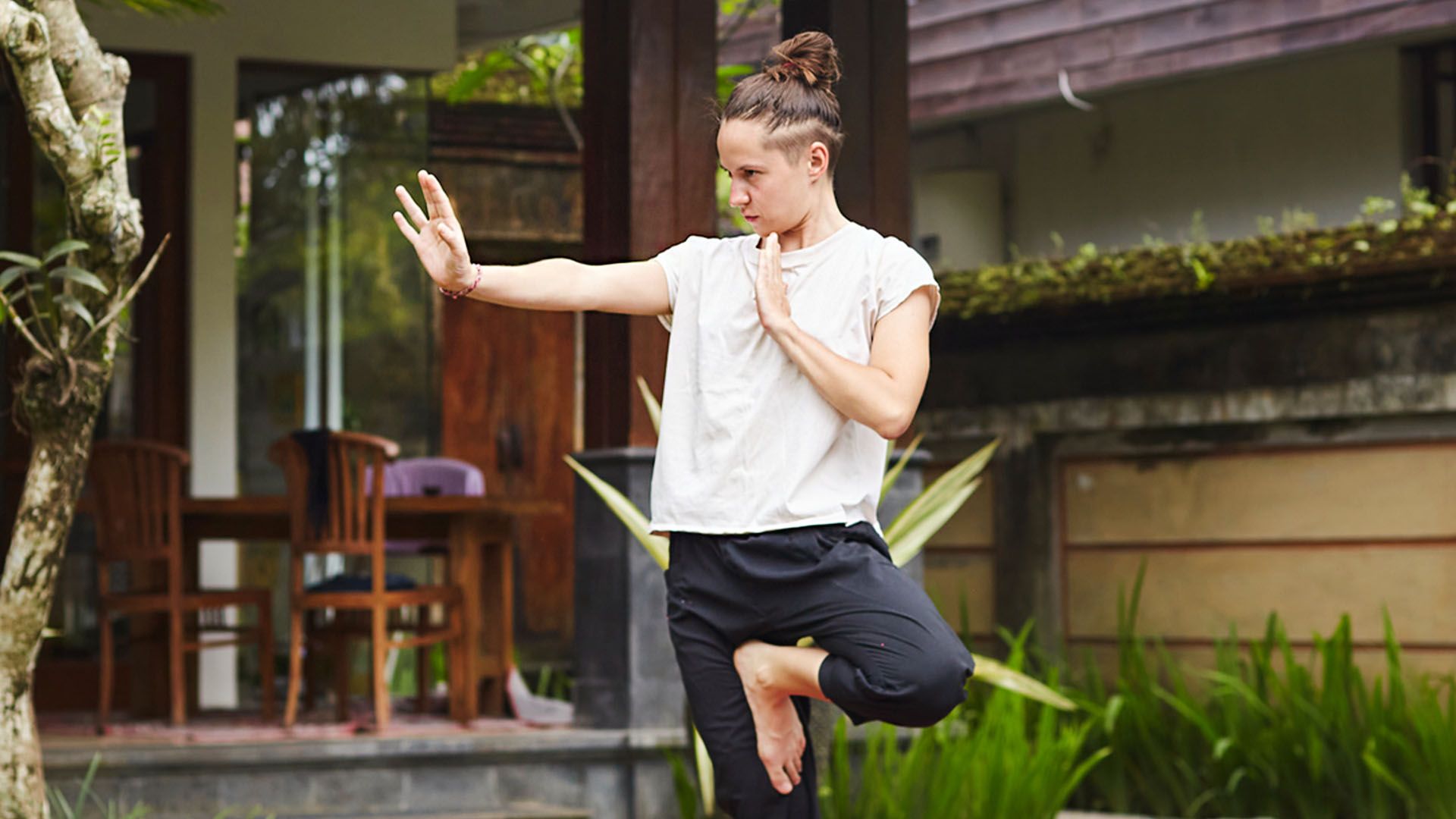 Person stands outside practicing Qigong