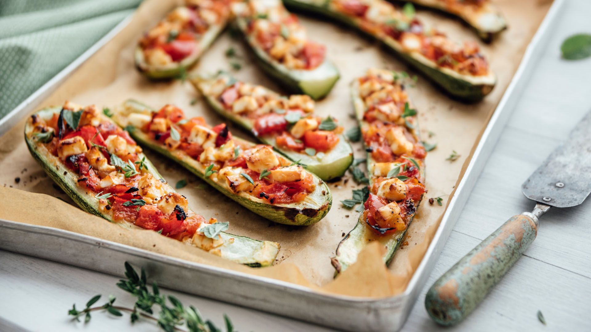 A plate of freshly baked stuffed summer zucchini, one of the nine best delicious and healthy summer superfoods you can eat during the summertime.