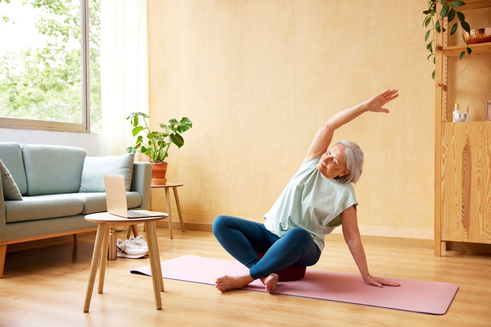 Senior woman stretching during online Feldenkrais Method class