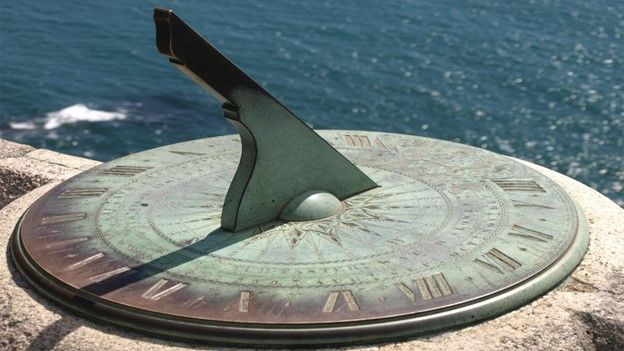 Old-looking sundial near the ocean