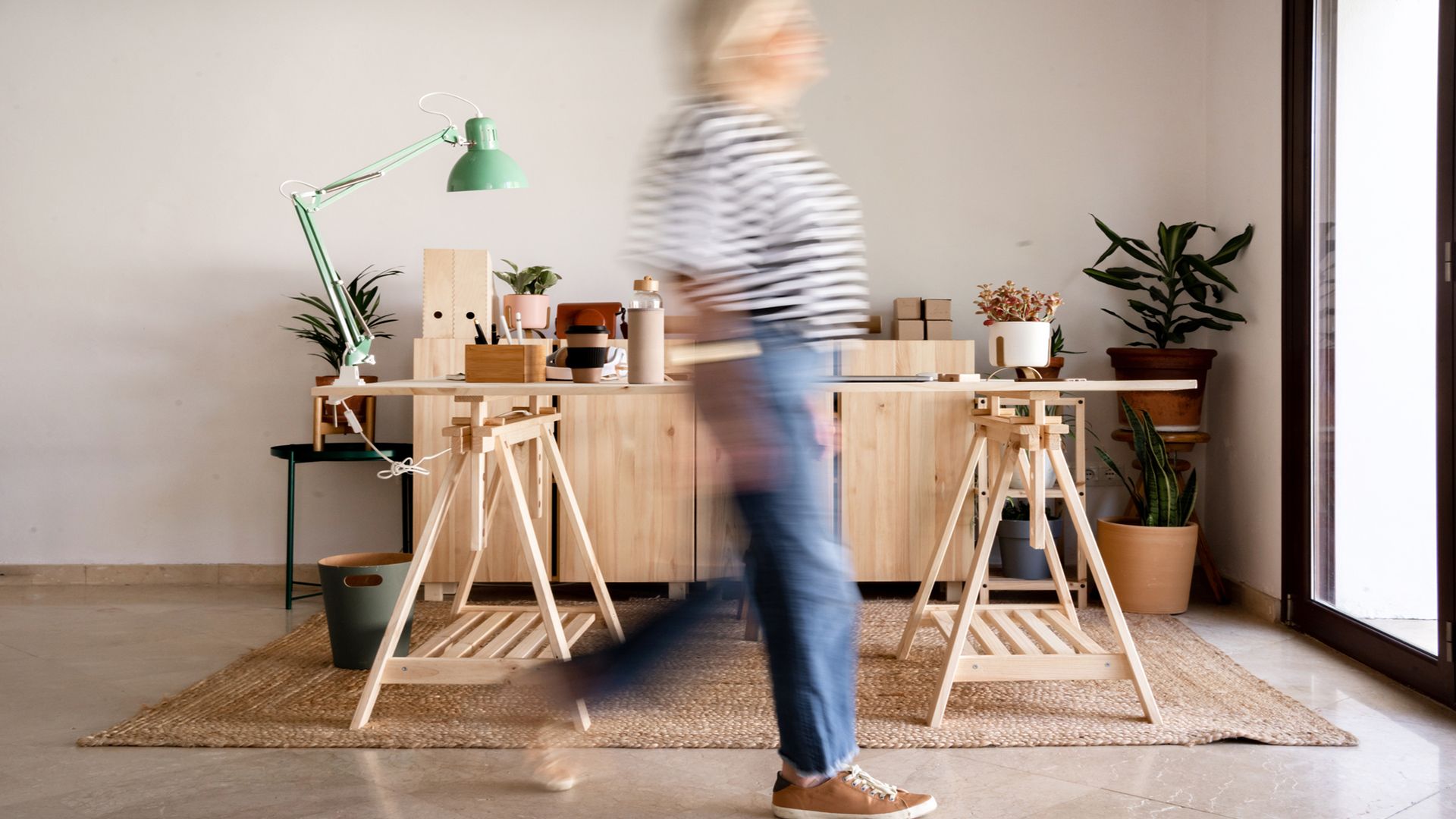 Side view of defocused businesswoman walking at home office